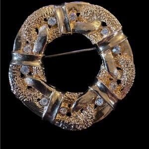 vintage gold-tone rhinestone wreath brooch with rhinestones.